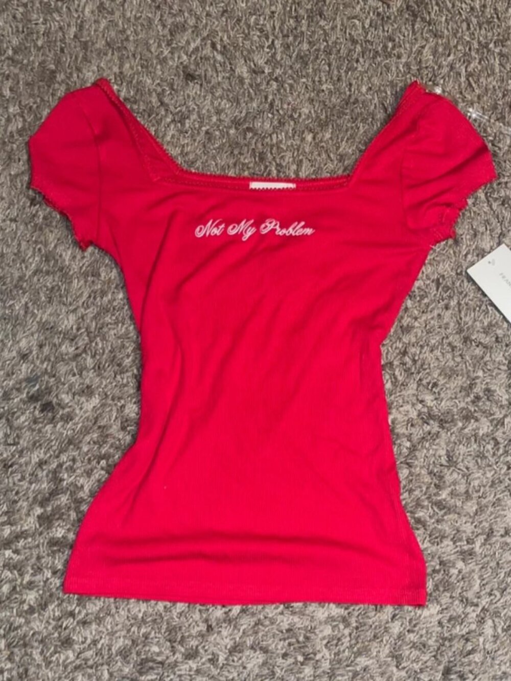 Red top with white cursive text reading 'Not My Problem' in size M